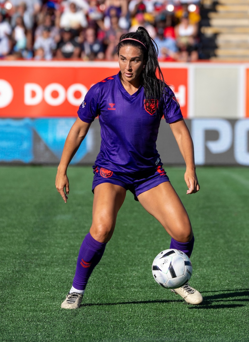 Sonia dribbles the ball during a match